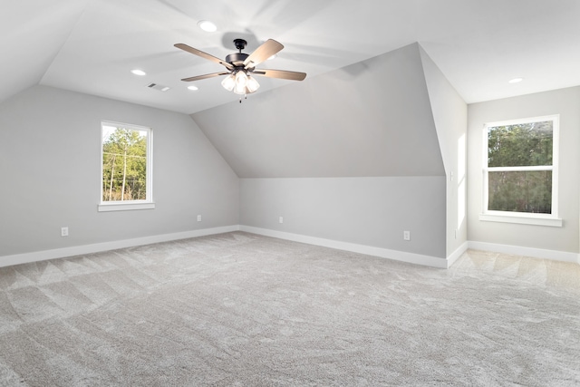 bonus room with ceiling fan, lofted ceiling, and light carpet