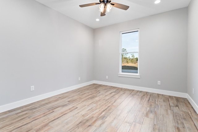 empty room with ceiling fan and light hardwood / wood-style flooring