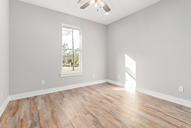 empty room with ceiling fan and light hardwood / wood-style flooring