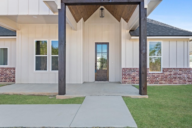 doorway to property with a lawn