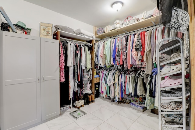 spacious closet with light tile patterned flooring