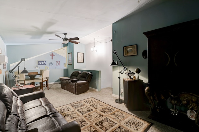 living room with ceiling fan, carpet, and vaulted ceiling