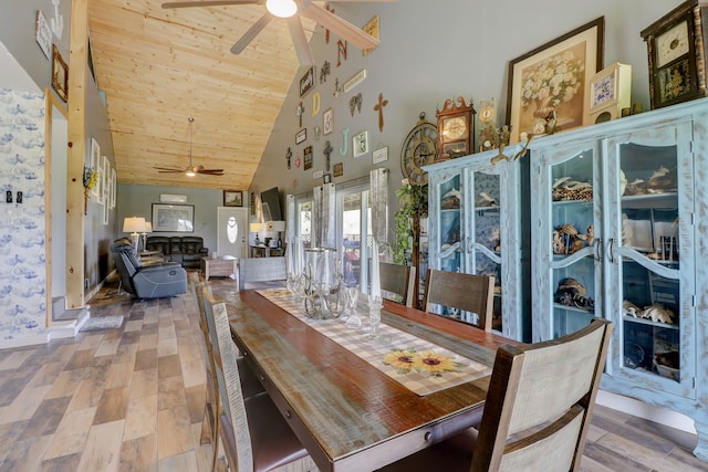 dining room with ceiling fan, high vaulted ceiling, wood-type flooring, and wooden ceiling