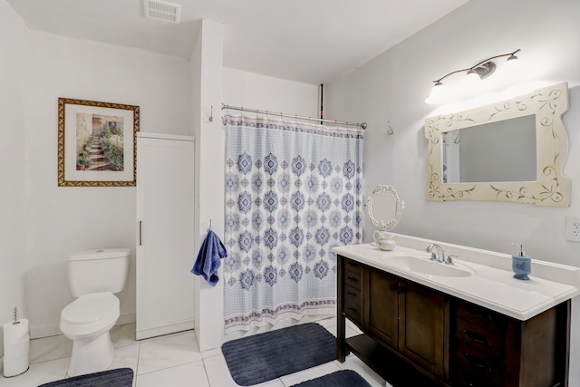 bathroom featuring toilet, curtained shower, vanity, and tile patterned flooring