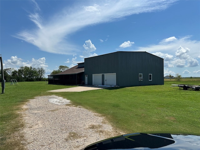 view of outdoor structure with a garage and a lawn