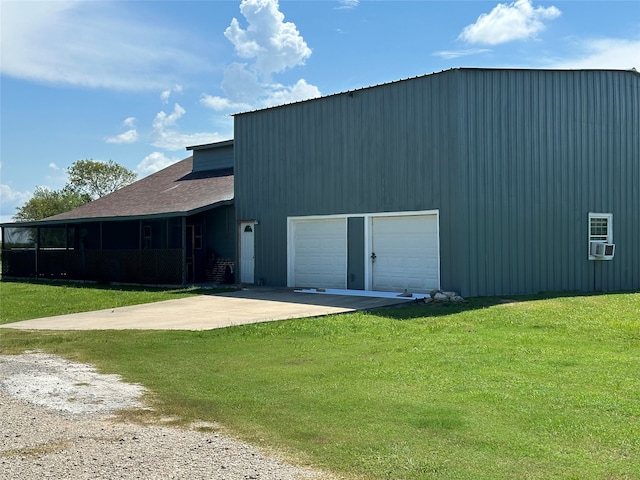 exterior space featuring a garage and a lawn