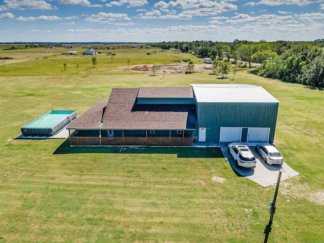 birds eye view of property with a rural view