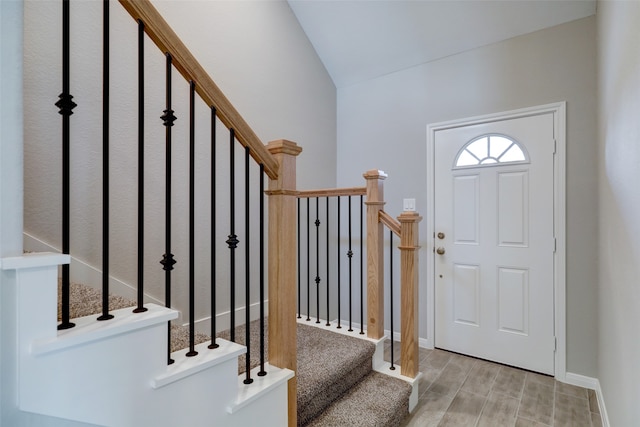 entryway featuring light hardwood / wood-style floors and vaulted ceiling