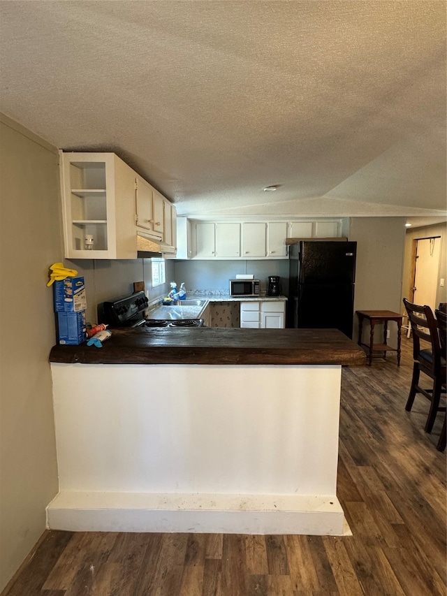 kitchen with dark hardwood / wood-style floors, a textured ceiling, black appliances, and white cabinetry