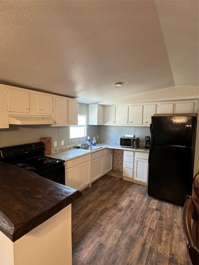 kitchen with sink, dark hardwood / wood-style flooring, white cabinets, black appliances, and a textured ceiling