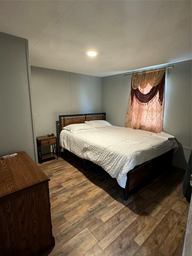 bedroom with hardwood / wood-style floors