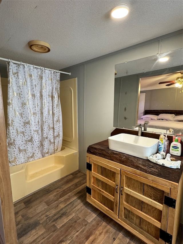 bathroom featuring vanity, wood-type flooring, ceiling fan, and shower / bathtub combination with curtain