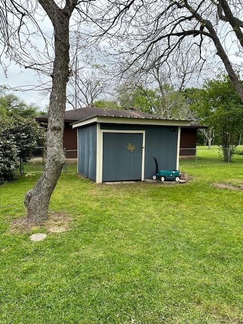 view of outbuilding with a yard