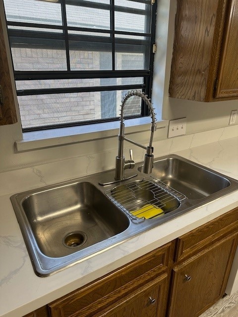 details featuring dark brown cabinetry and sink