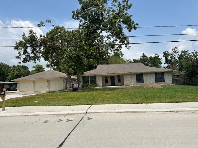 ranch-style house with a garage and a front yard