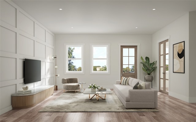 living room with light hardwood / wood-style flooring and a wealth of natural light