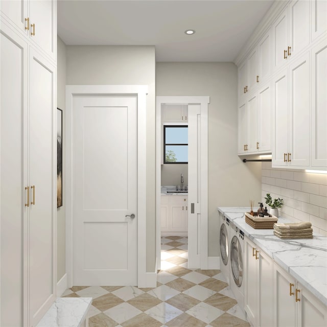 interior space featuring white cabinets, light stone countertops, independent washer and dryer, sink, and light tile floors