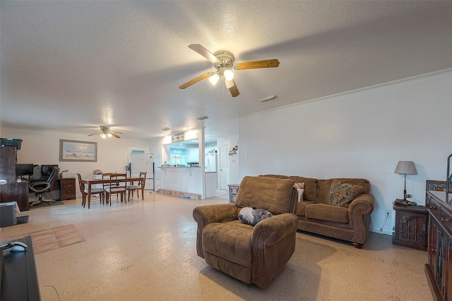 living room featuring ceiling fan and a textured ceiling