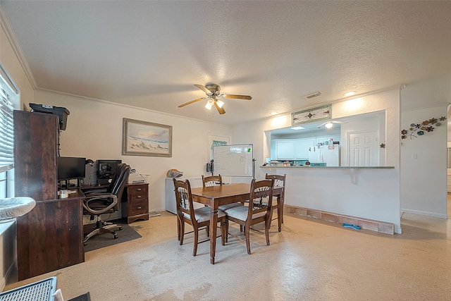 dining room featuring ceiling fan and a textured ceiling