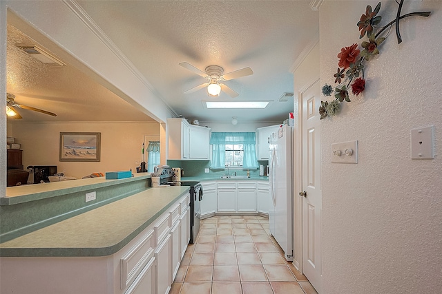 kitchen with light tile floors, ceiling fan, kitchen peninsula, stainless steel electric range, and white cabinets