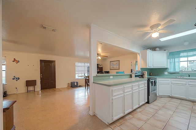 kitchen featuring ceiling fan, kitchen peninsula, range with two ovens, and white cabinets