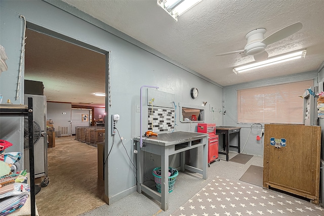 office space featuring ceiling fan and a textured ceiling