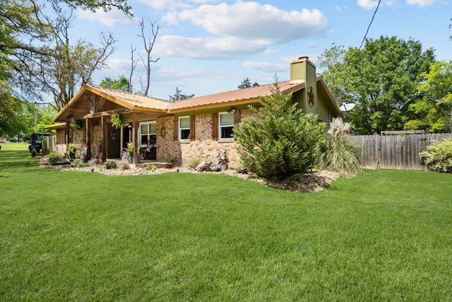 rear view of house featuring a yard