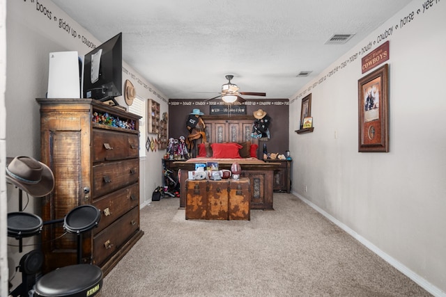 carpeted bedroom with a textured ceiling and ceiling fan