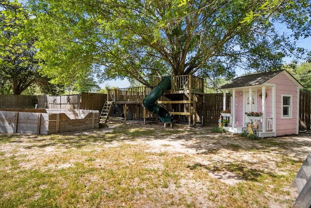 view of yard featuring a playground and an outdoor structure