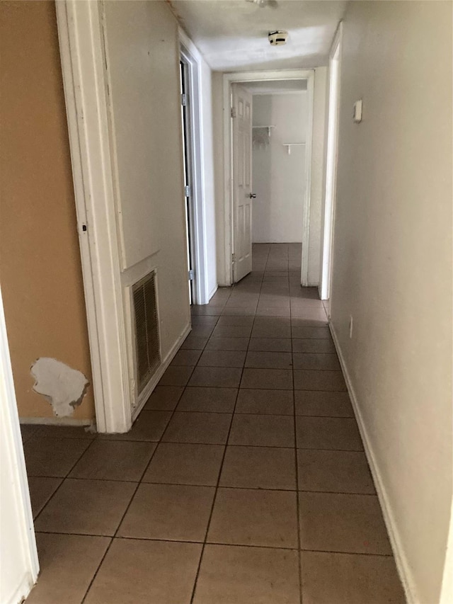 corridor with dark tile patterned floors