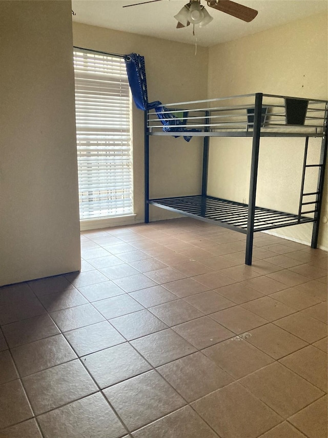 unfurnished bedroom featuring tile patterned floors and ceiling fan