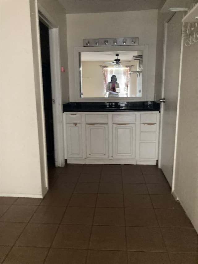 hallway featuring dark tile patterned flooring