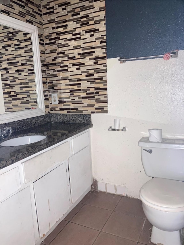 bathroom featuring tile patterned flooring, vanity, and toilet