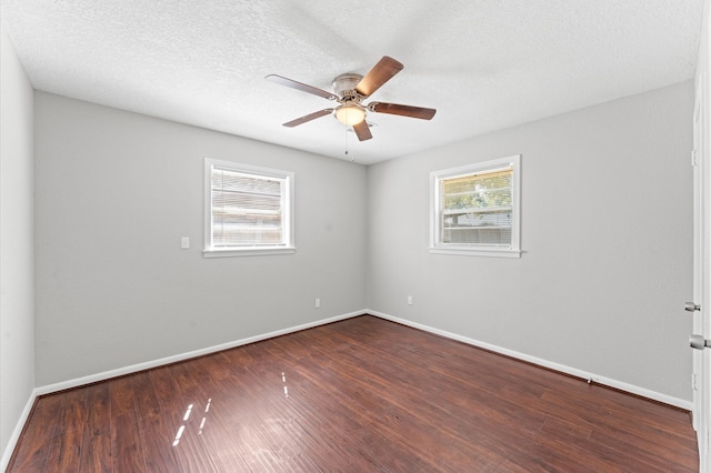 unfurnished room featuring dark hardwood / wood-style flooring, a textured ceiling, and ceiling fan