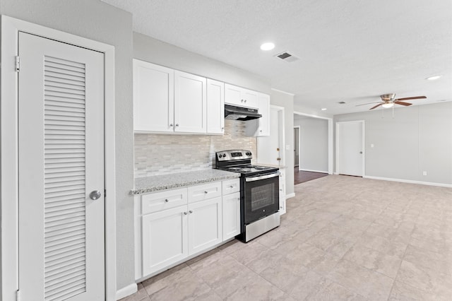 kitchen featuring stainless steel electric range, white cabinetry, tasteful backsplash, and ceiling fan