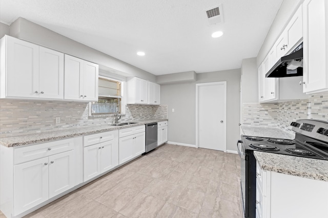 kitchen with light stone countertops, sink, appliances with stainless steel finishes, and white cabinetry