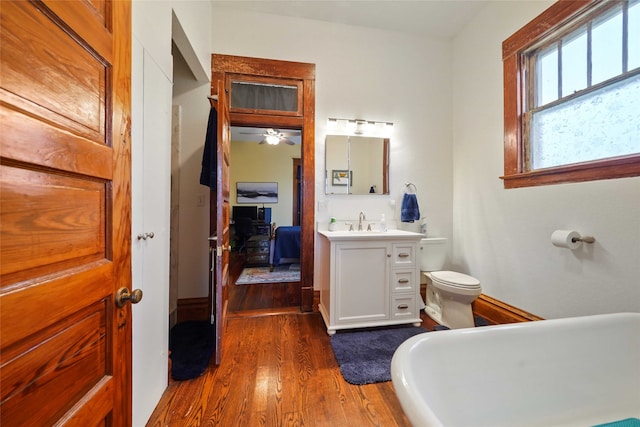 bathroom with ceiling fan, vanity, toilet, and hardwood / wood-style flooring