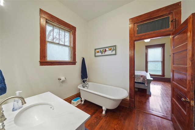 bathroom with a washtub, hardwood / wood-style floors, sink, and plenty of natural light