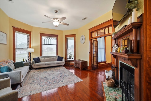 living room featuring ceiling fan and dark hardwood / wood-style floors