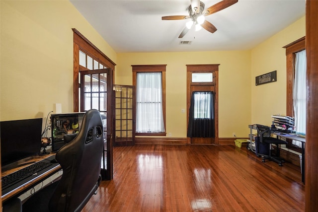 office featuring dark hardwood / wood-style floors and ceiling fan