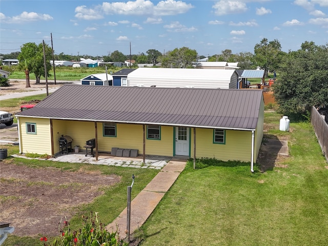 back of property featuring a lawn and a patio