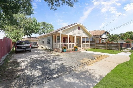 exterior space with covered porch and a yard