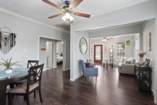 living room featuring dark hardwood / wood-style floors, ceiling fan, and ornamental molding