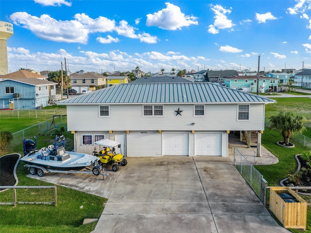 view of front of home with a front yard and a garage