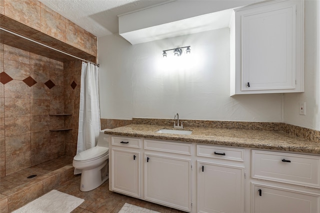 bathroom featuring a textured ceiling, toilet, a shower with curtain, vanity, and tile patterned flooring