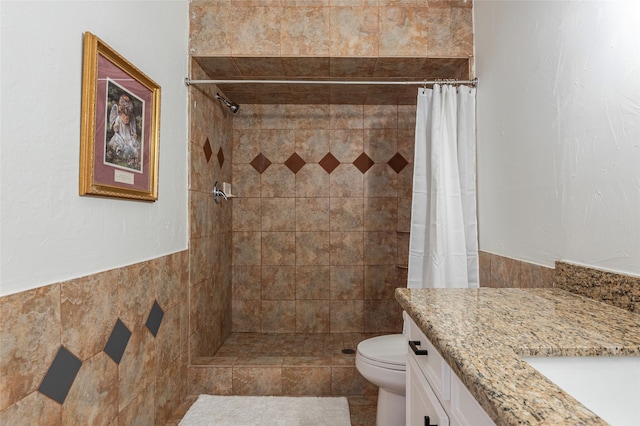 bathroom featuring vanity, tile walls, toilet, and a shower with shower curtain