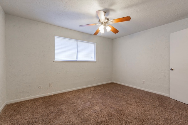 empty room featuring ceiling fan, a textured ceiling, and carpet floors