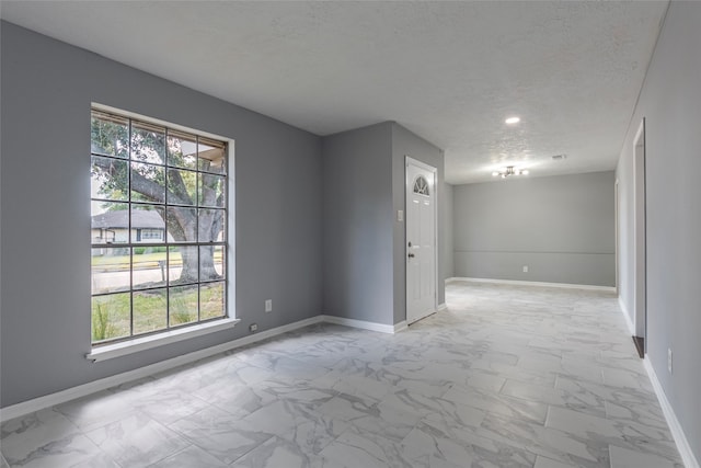 spare room with a textured ceiling