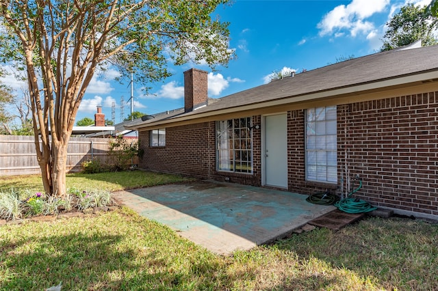 back of house featuring a yard and a patio