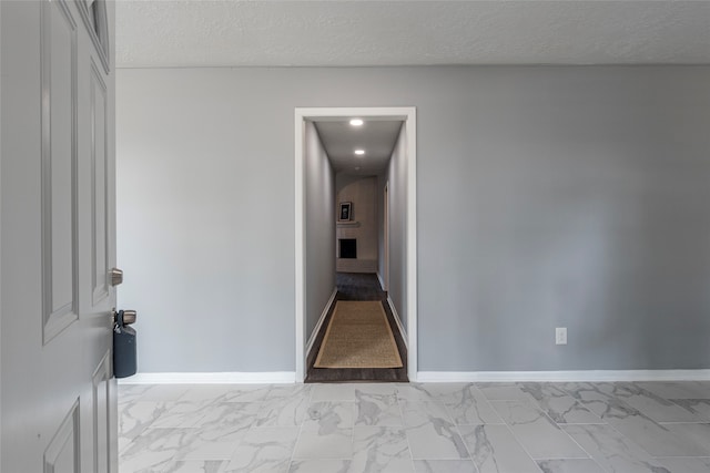 corridor with a textured ceiling